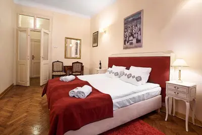 a bedroom with a large bed with towels on it at Gołębia 8 Residence in Kraków
