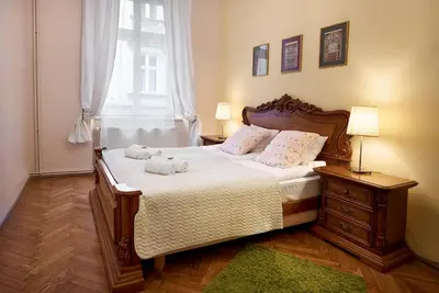 a bedroom with a bed with two stuffed animals on it at Gołębia 8 Residence in Kraków