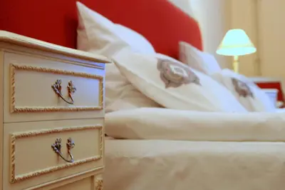 a bedroom with a bed with white sheets and pillows at Gołębia 8 Residence in Kraków