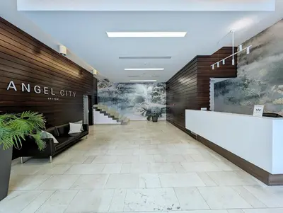 a lobby of an angel city building with a staircase at Turnau City Aparthotel in Kraków