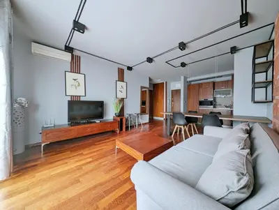 an open living room with a couch and a table at Turnau City Aparthotel in Kraków