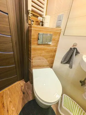 a small bathroom with a toilet and a sink at Apartament Parkowy Rabka in Rabka