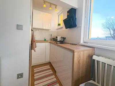 a small kitchen with a sink and a window at Apartament Parkowy Rabka in Rabka