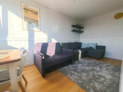 a living room with a couch and a table at Apartament Parkowy Rabka in Rabka
