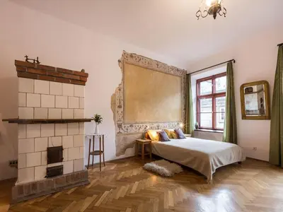 a bedroom with a bed and a fireplace at Nicholas Studio in Kraków