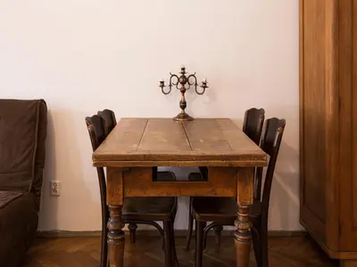 a dining room table with chairs and a candlesticks on top at Nicholas Studio in Kraków