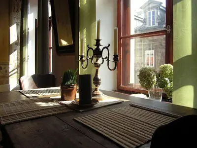 a lamp sitting on a table in front of a window at Nicholas Studio in Kraków