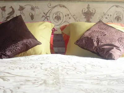 a bed with three pillows on top of it at Nicholas Studio in Kraków