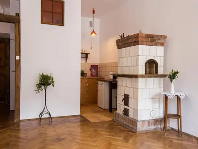 a kitchen with a brick oven in the middle of a room at Nicholas Studio in Kraków