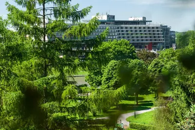 a view of a park with a building in the background at Kazimierz Apartment in Kraków
