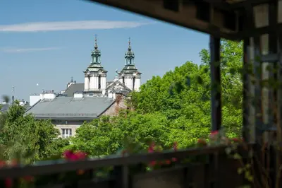 a view from a window of a building with two towers at Kazimierz Apartment in Kraków