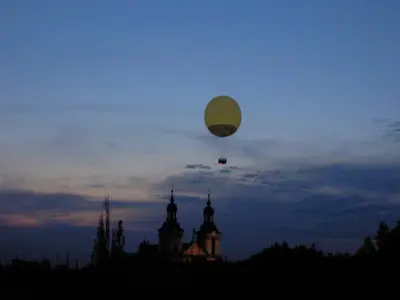 a balloon flying in the sky over a building at Kazimierz Apartment in Kraków