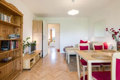 a living room with a table and a couch at Kazimierz Apartment in Kraków