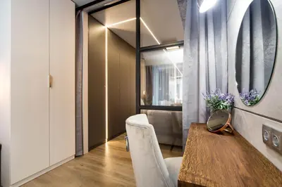 a dining room with a table and a mirror at Jacuzzi Apartments in Kraków
