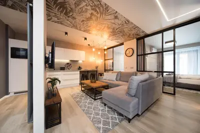 a living room with a couch and a table at Jacuzzi Apartments in Kraków