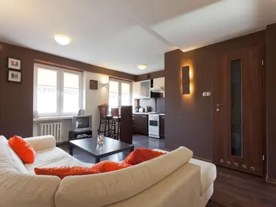 a living room with a white couch and a table at Irish Apartment in Kraków
