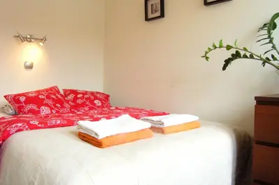 a bedroom with a bed with towels on it at Irish Apartment in Kraków