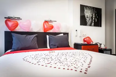 a bedroom with a bed with hearts on it at Komorowski Luxury Guest Rooms in Kraków