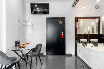 a dining room with a table and a tub at Komorowski Luxury Guest Rooms in Kraków
