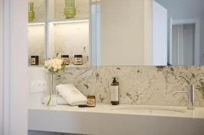 a bathroom counter with a sink and a mirror at Feniks Fragola Apartments in Kraków