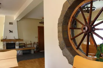 a living room with a large wooden wheel on the wall at Nad Zalewem in Jaszczurowa