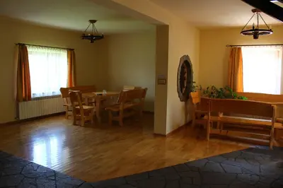 a dining room with a table and chairs at Nad Zalewem in Jaszczurowa
