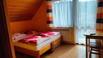 a small bed in a room with a window at Nad Zalewem in Jaszczurowa
