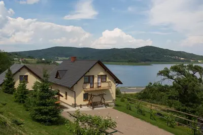 a house with a view of a lake at Nad Zalewem in Jaszczurowa
