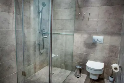 a bathroom with a shower and a toilet at Apartamenty Straszewskiego in Kraków