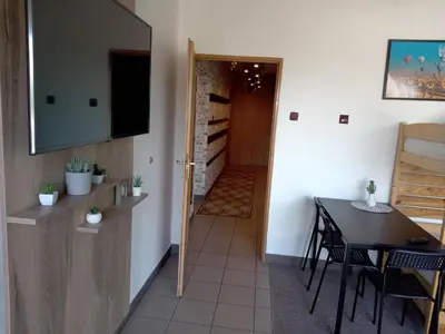 a room with a table and a dining room at Apartament Kapi in Kalwaria Zebrzydowska