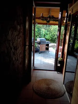 an open door to a patio with a grill at Apartament Kapi in Kalwaria Zebrzydowska