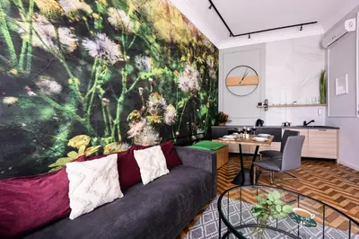 a living room with a couch and a wall mural at Arts Apartments - Kraków Old Town in Kraków