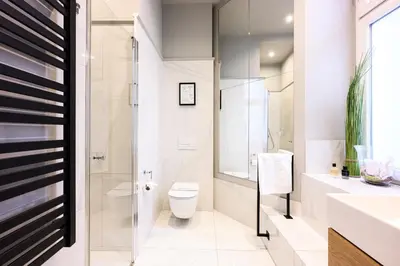 a bathroom with a toilet and a glass shower at Arts Apartments - Kraków Old Town in Kraków