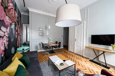 a living room with a couch and a table at Arts Apartments - Kraków Old Town in Kraków