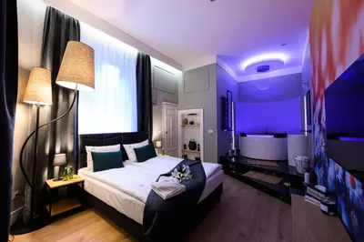a bedroom with a large bed and a purple room at Arts Apartments - Kraków Old Town in Kraków