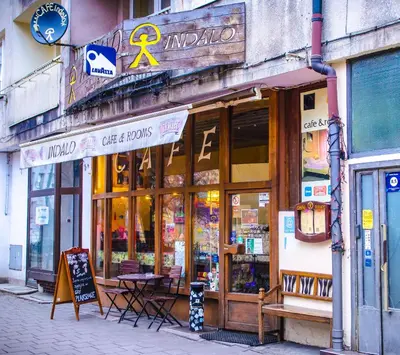 a store with tables and chairs in front of a building at Indalo Rooms in Kraków