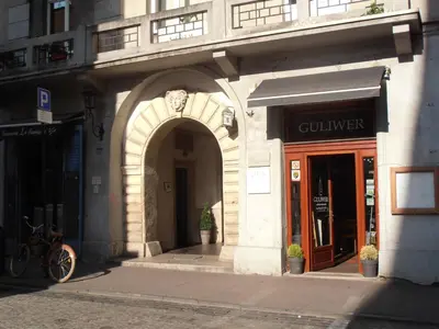 a building with an archway in front of a store at Apartamenty Rudi in Kraków