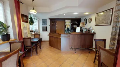 a bar in a restaurant with chairs and a counter at Noclegi Czarna Perła in Kraków