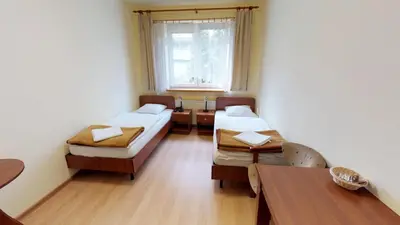 a hospital room with two beds and a table at Noclegi Czarna Perła in Kraków