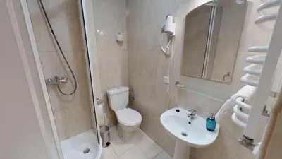 a bathroom with a toilet and a sink and a shower at Noclegi Czarna Perła in Kraków