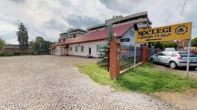 a building with a sign for a car dealership at Noclegi Czarna Perła in Kraków