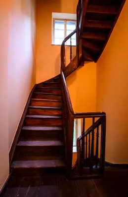 a wooden staircase in a room with a window at Apartamenty Winnicy Kresy II in Kraków