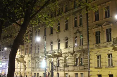 a large building with a tree in front of it at Apartamenty Winnicy Kresy II in Kraków