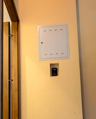 a door with a light switch on the wall at Apartamenty Winnicy Kresy II in Kraków