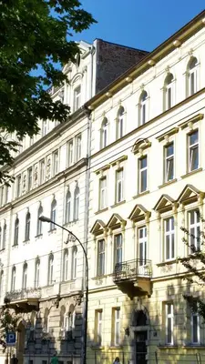 a large white building with a lot of windows at Apartamenty Winnicy Kresy II in Kraków