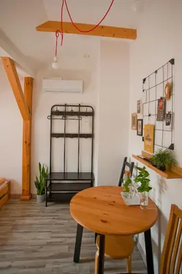 a room with a wooden table and a bed at Hostel 33 in Trzebinia
