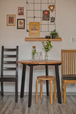 a table with two chairs and a table with plants on it at Hostel 33 in Trzebinia
