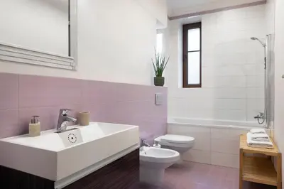 a bathroom with a white sink and a toilet at Liv'Inn Aparthotel in Kraków
