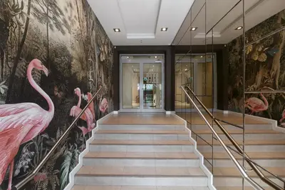 a hallway with pink flamingos on the wall at Liv'Inn Aparthotel in Kraków