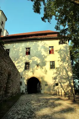 a large white building with a gate and a driveway at Dom Gości Opactwa Benedyktynów in Tyniec